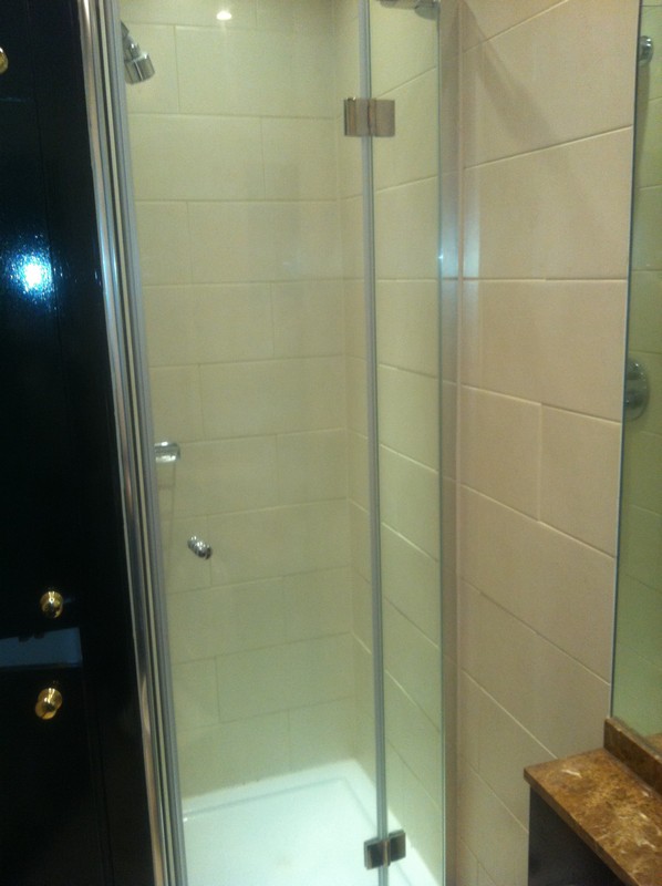 Frameless glass shower enclosure with chrome fittings in Harrow