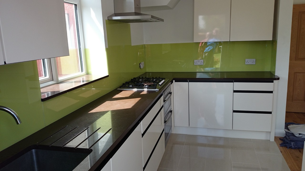 Lime green glass kitchen splashback installed by Harrow glaziers