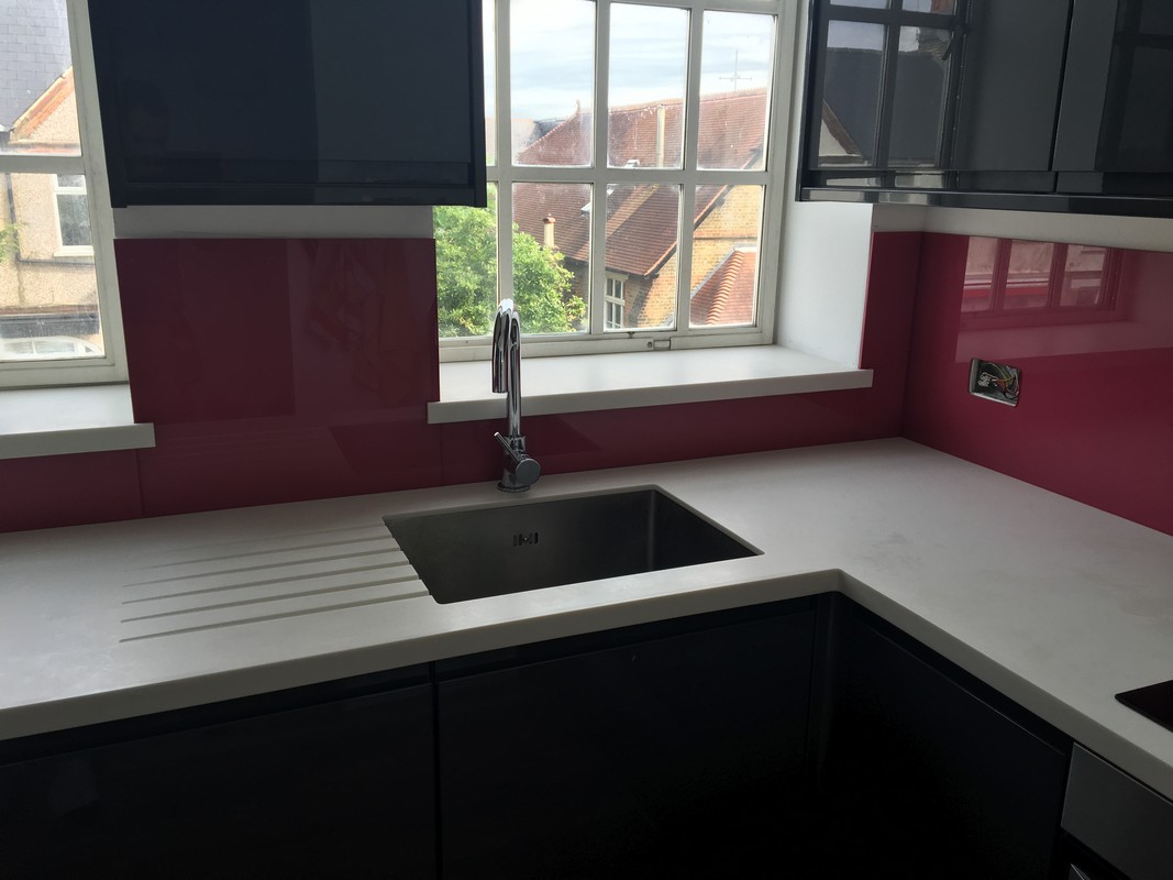 Deep plum coloured glass splashback in modern Harrow kitchen
